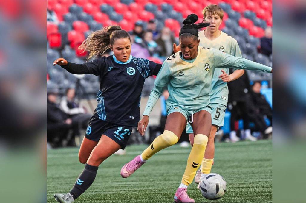 Keera Melenhorst (12) attempts to get the ball from Latifah Abdu (99) during the May 6 Vancouver Rise FC vs Ottawa Rapid FC match in Ottawa. (@NorthernSuperLg/ X)
