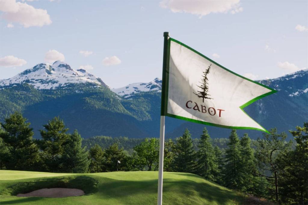 A flag waves in the wind at Cabot Revelstoke, a luxury 18-hole golf course opening alongside Revelstoke Mountain Resort in 2027 after preview play this fall. (Photo courtesy Cabot Revelstoke)