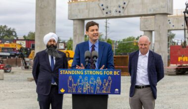 Premier David Eby, at microphone, was joined by Surrey Centre MP Randeep Sarai and B.C. Minister of Transportation and Transit Mike Farnworth at a May 8 event marking the progress of the Surrey Langley SkyTrain project, at the site of the future Willowbrook station on the Langley-Surrey border. (B.C. Government/Flickr)