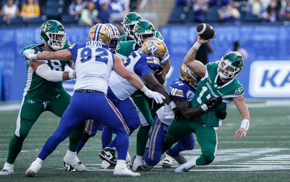 JOHN WOODS / THE CANADIAN PRESS FILES
Winnipeg Blue Bombers defensive lineman Kemari Munier-Bailey (43) sacked Saskatchewan Roughriders quarterback Tommy Stevens in last year’s pre-season game in Winnipeg.