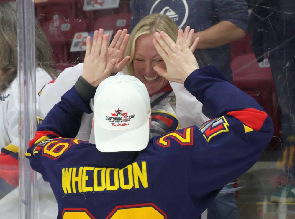 Hayden Wheddon shares a moment with his family after clinching the Centennial Cup in Summerside, P.E.I. May 17. (Cassidy Dankochik / The Carillon)