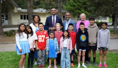 PAC co-chair Joyt Uppal, Delta North MLA Ravi Kahlon, school board chair Joe Muego and trustee Val Windsor, back row from left, pose with students outside Sunshine Hills Elementary on Friday, May 8, after the province announced $200,000 to replace the North Delta school&rsquo;s 35-year-old playground. (James Smith/North Delta Reporter photo)