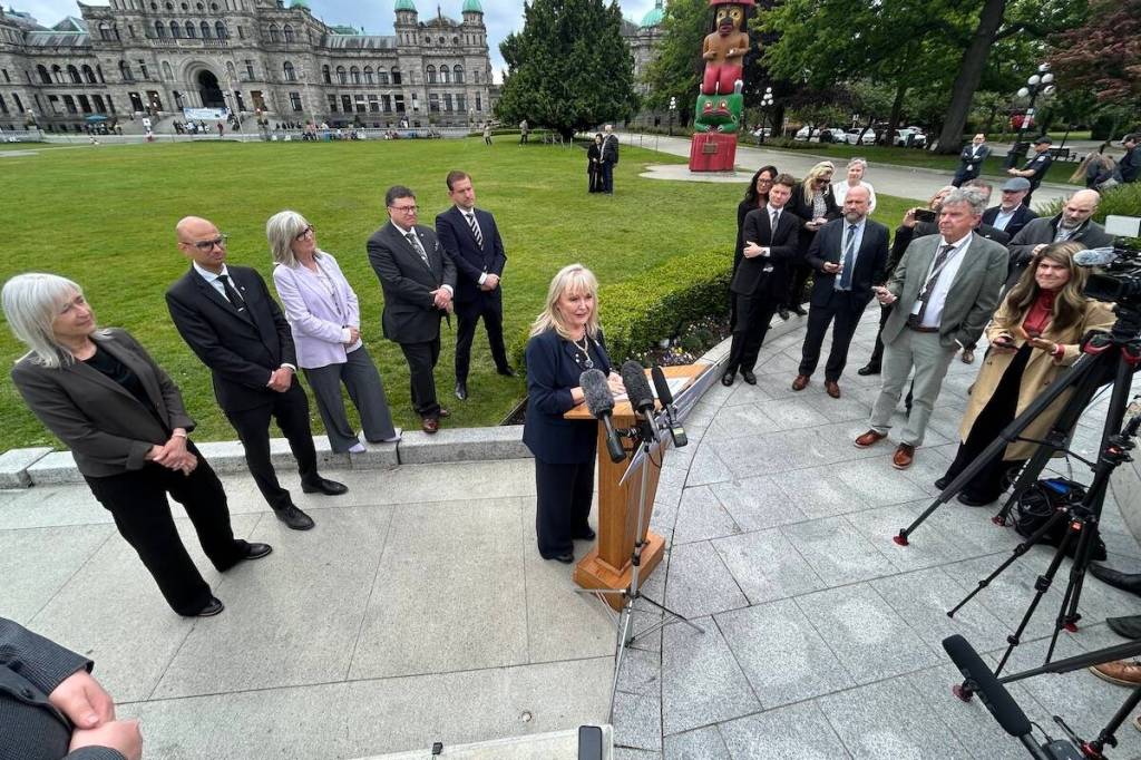Findlay speaks to the media in Victoria before refusing to take questions and fleeing in an SUV. (Mark Page/Black Press Media)