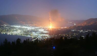 The construction site for a long-term care facility in Penticton erupted into flame late on May 27, with flames visible across Skaha Lake. Highway 97 remained closed near the scene on May 28. (City of Penticton webcam)