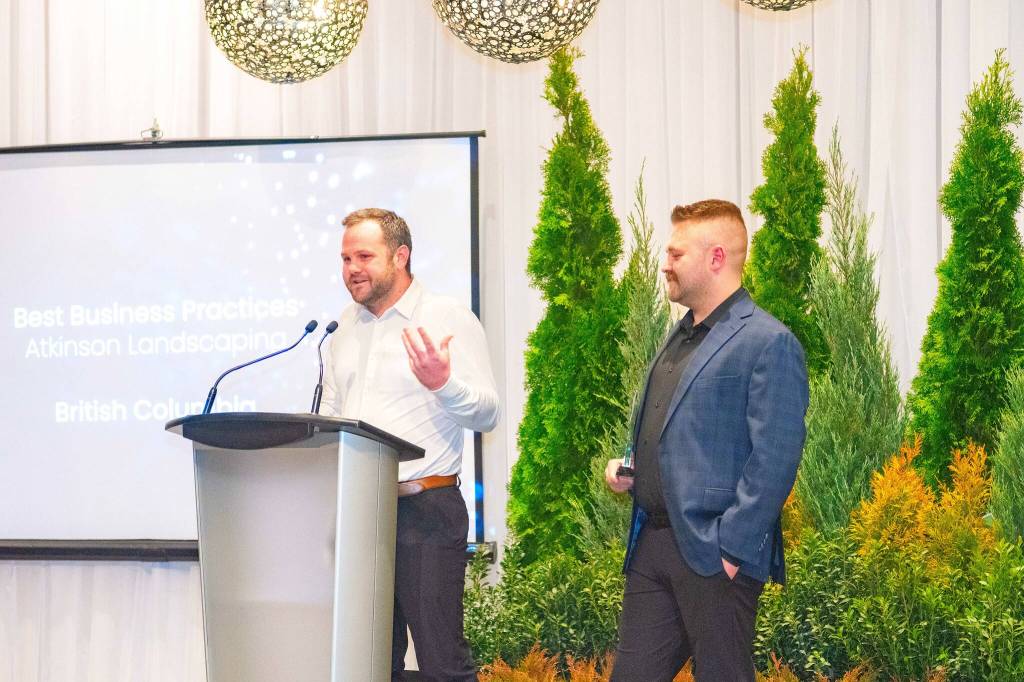 Dave Endacott (left) and Matt Atkinson, co-owners of Atkinson Landscaping, accept a national business award earlier this year in Toronto. The company said the win offered a chance to reflect on their last decade-plus in business. (Photo submitted to Cloverdale Reporter/Atkinson Landscaping)
