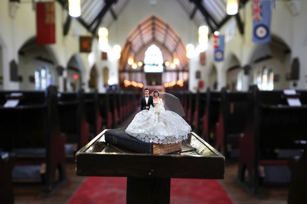 All Saints is encouraging people to contribute memorabilia from weddings held at the church, such as this 1940s cake topper. (Ruth Bonneville / Free Press)