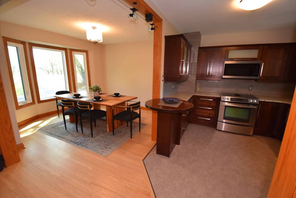 The dining room is flooded with light and flows seamlessly into the beautifully finished kitchen.