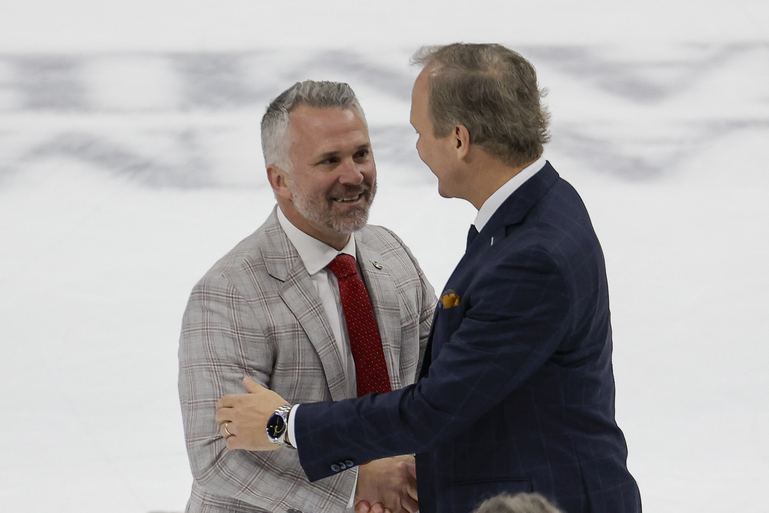 Montreal Canadiens head coach Martin St. Louis and Tampa Bay Lightning head coach Jon Cooper talk after a game.