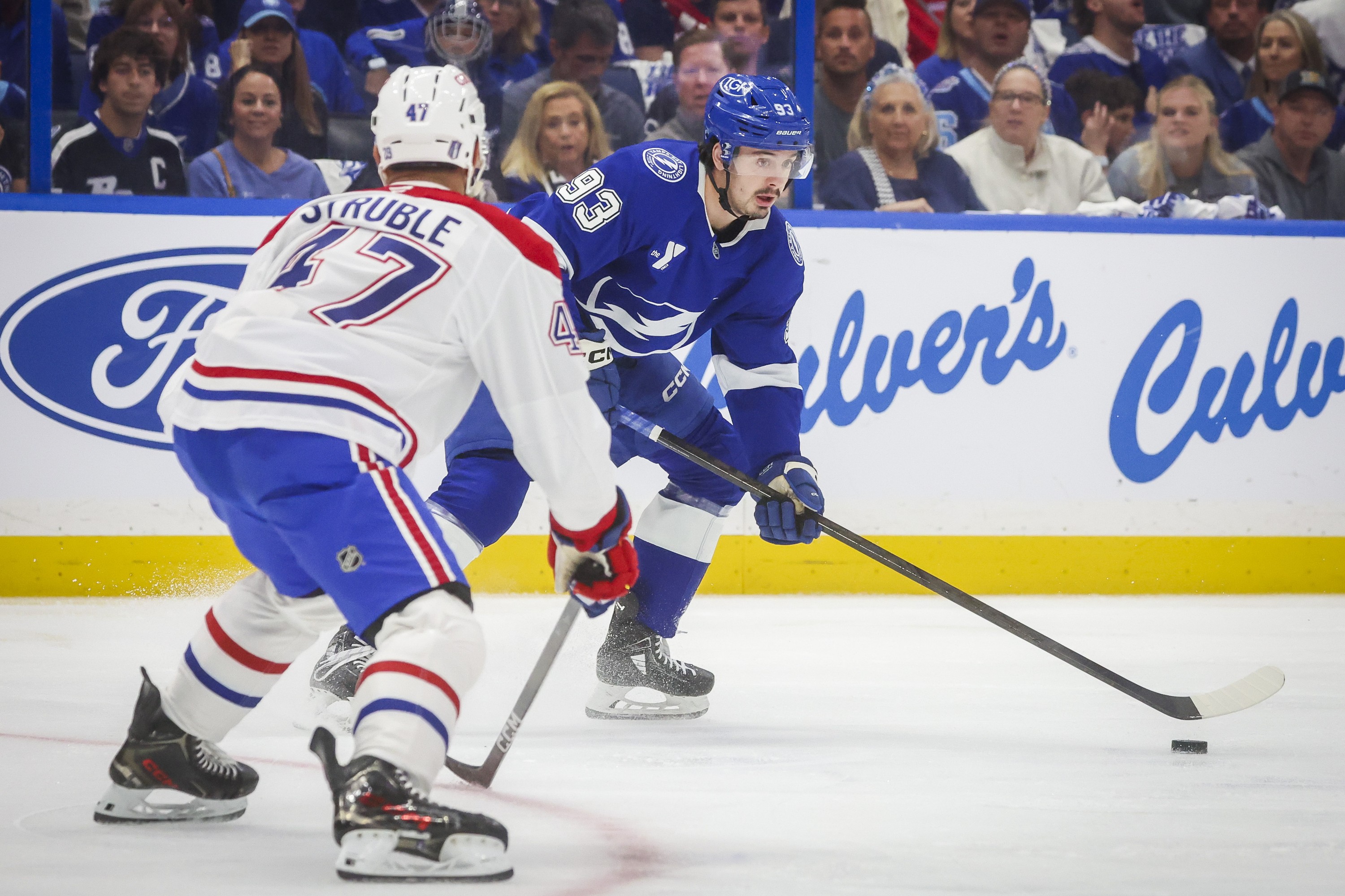 Tampa Bay Lightning centre Gage Goncalves moves the puck as Montreal Canadiens defenceman Jayden Struble looks on