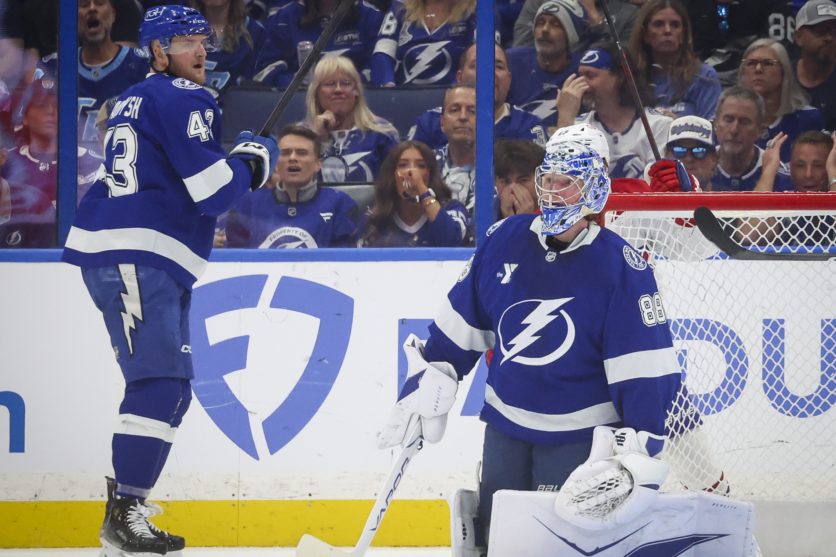 Tampa Bay Lightning goaltender Andrei Vasilevskiy and defenceman Darren Raddysh react to a goal from the other team