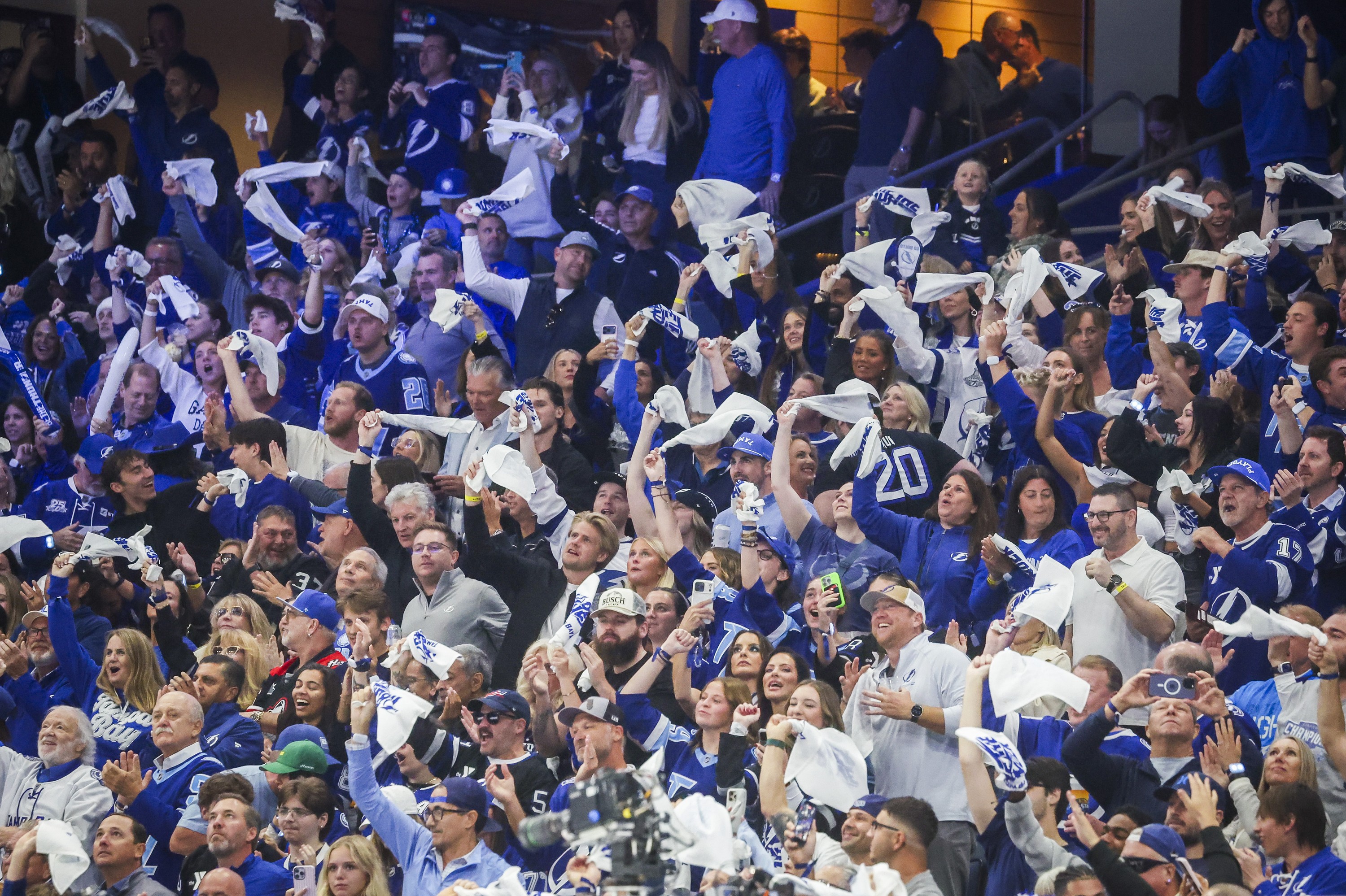 Tampa Bay Lightning fans wave towels after a goal