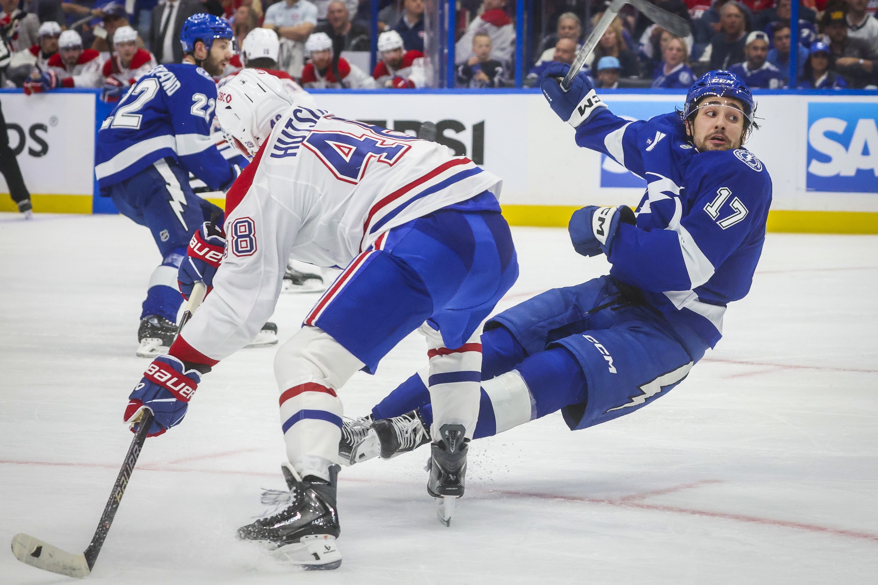 Tampa Bay Lightning centre Dominic James falls to the ice after colliding with Montreal Canadiens defenceman Lane Hutson