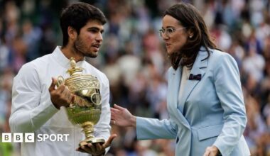 Carlos Alcaraz of Spain talks to AELTC chief executive Sally Bolton while holding the Wimbledon winner's trophy