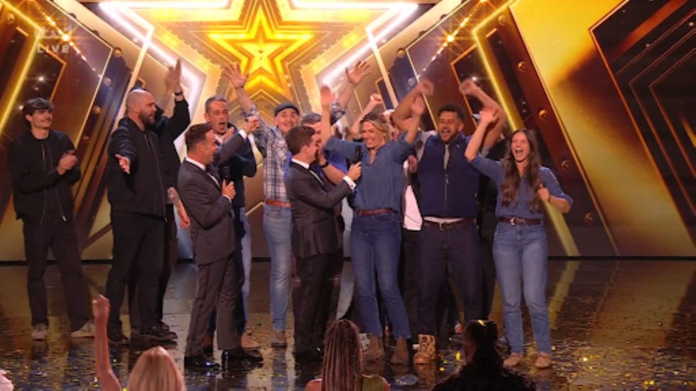 participants celebrating on stage with a presenter