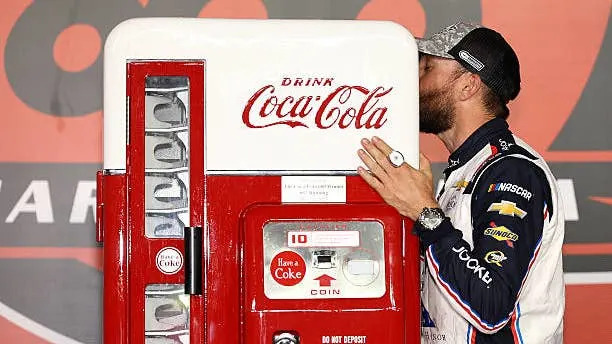 Ross Chastain Kisses His Coca-Cola Vending Machine Prize. (Photo by David Jensen/Getty Images)(Photo by David Jensen/Getty Images)