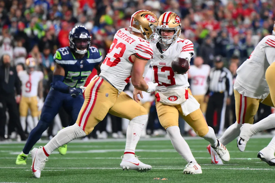 San Francisco 49ers quarterback Brock Purdy hands off to running back Christian McCaffrey (23) against the Seattle Seahawks.