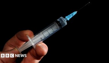 A generic image of a needle in a person's hand