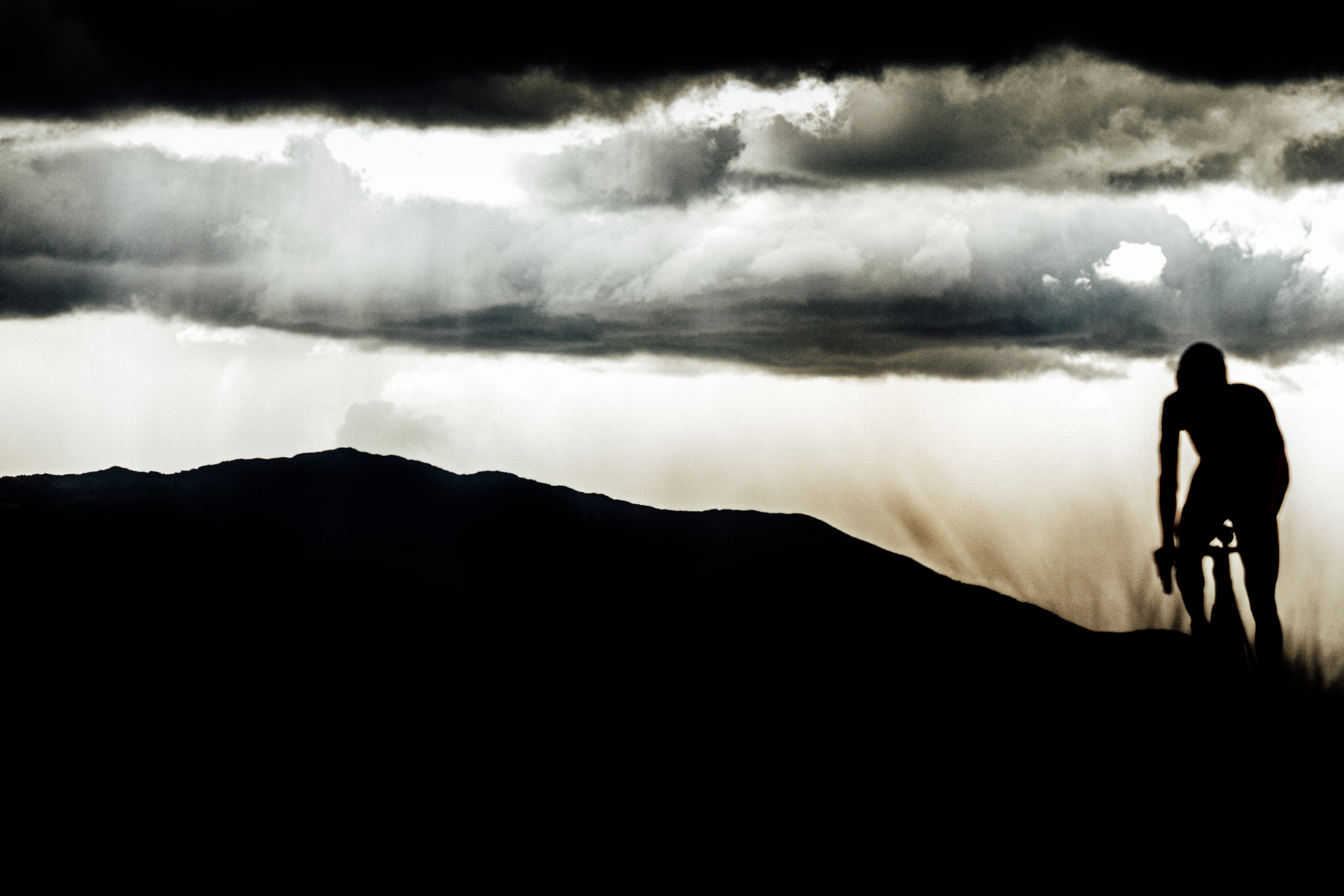 An unknown rider bounces on the pedals as he nears the Blockhaus summit, all the while the light begins to fade. Images from 2026 Giro d'Italia stage 7 to Blockhaus