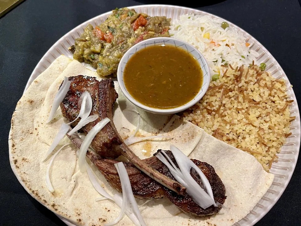 Lamb chops at Yan’s Restaurant in the ByWard Market. In the centre is a bowl of tkhemali, a Georgian sour plum-based dip.
