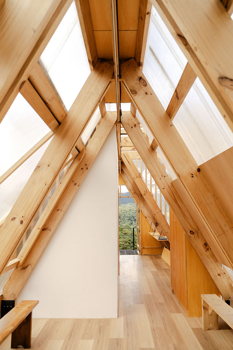 translucent polycarbonate skin envelopes triangular shelter elevated on stilts in ecuador - 5