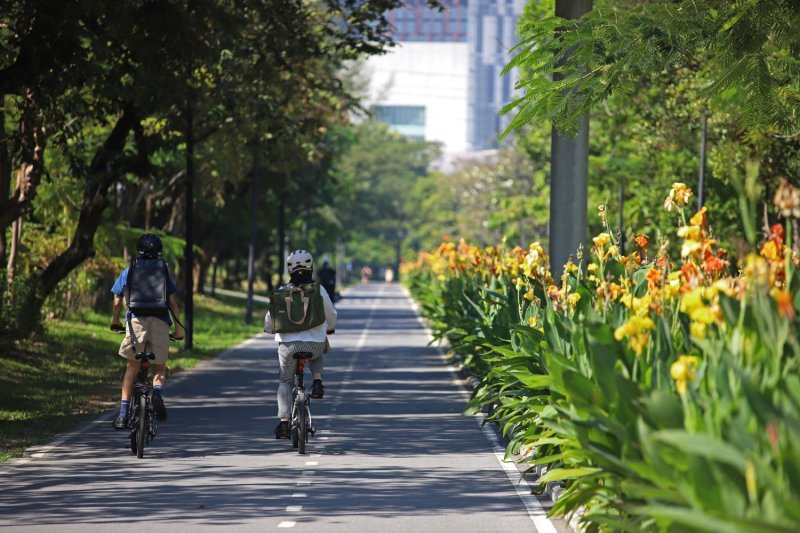 People cycle at Benjakitti Park. Varuth Hirunyatheb
