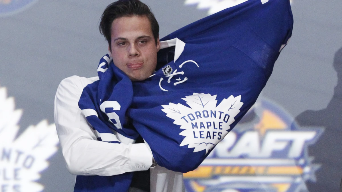 Auston Matthews puts on a team jersey after being selected as the number one overall draft pick by the Toronto Maple Leafs in the first round of the 2016 NHL Draft at the First Niagara Center.