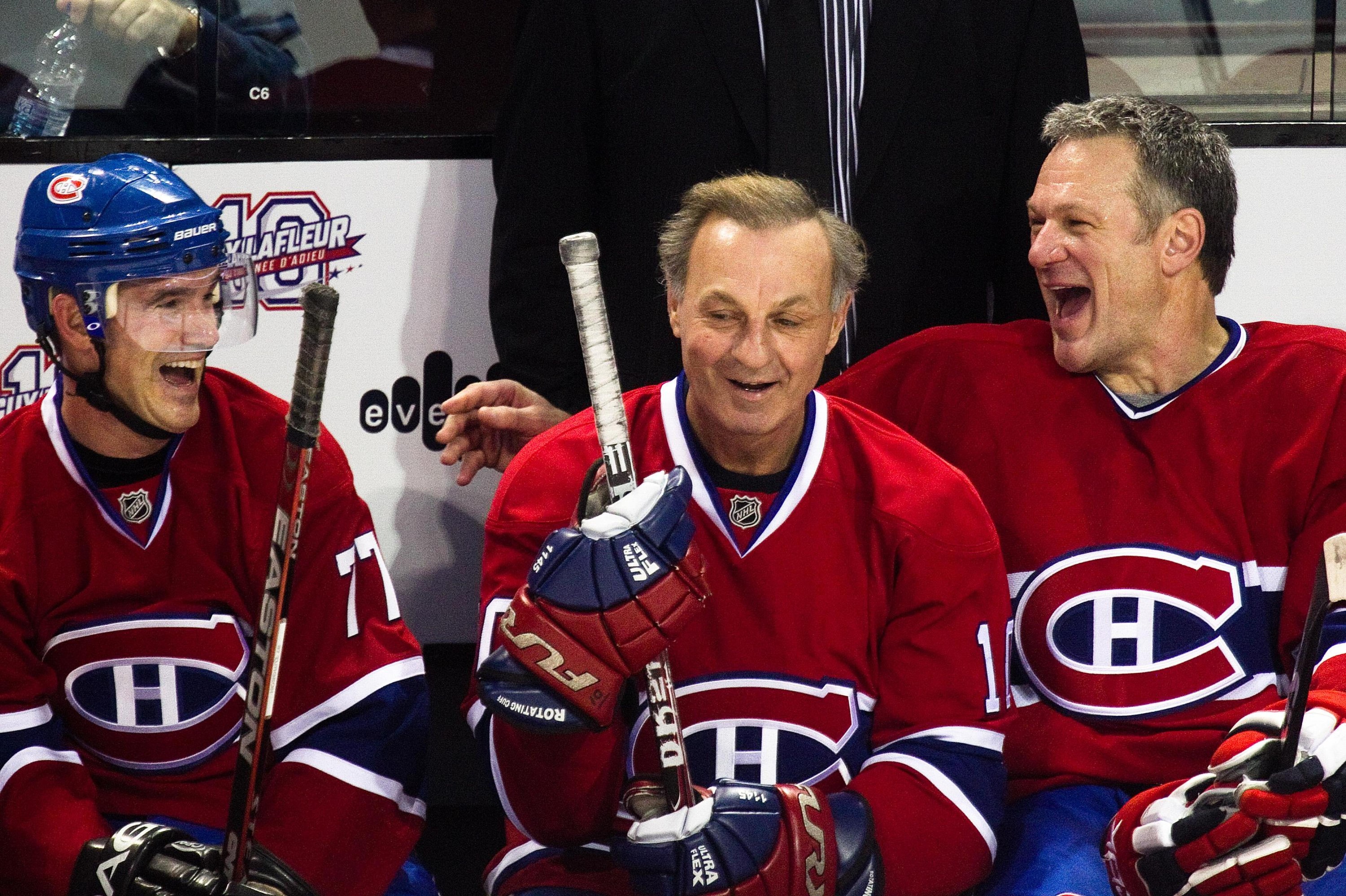 Playing with the Anciens Canadiens, hockey legend Guy Lafleur (centre) smiles along with teammates Pierre Turgeon (left) and Claude Lemieux (right).