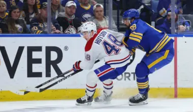 Montr&eacute;al Canadiens defenseman Lane Hutson (48) and Buffalo Sabres right wing Alex Tuch (89) go after a loose puck during the second period in game two of the second round of the 2026 Stanley Cup Playoffs at KeyBank Center.