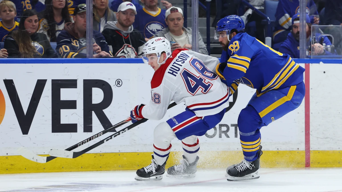 Montr&eacute;al Canadiens defenseman Lane Hutson (48) and Buffalo Sabres right wing Alex Tuch (89) go after a loose puck during the second period in game two of the second round of the 2026 Stanley Cup Playoffs at KeyBank Center.
