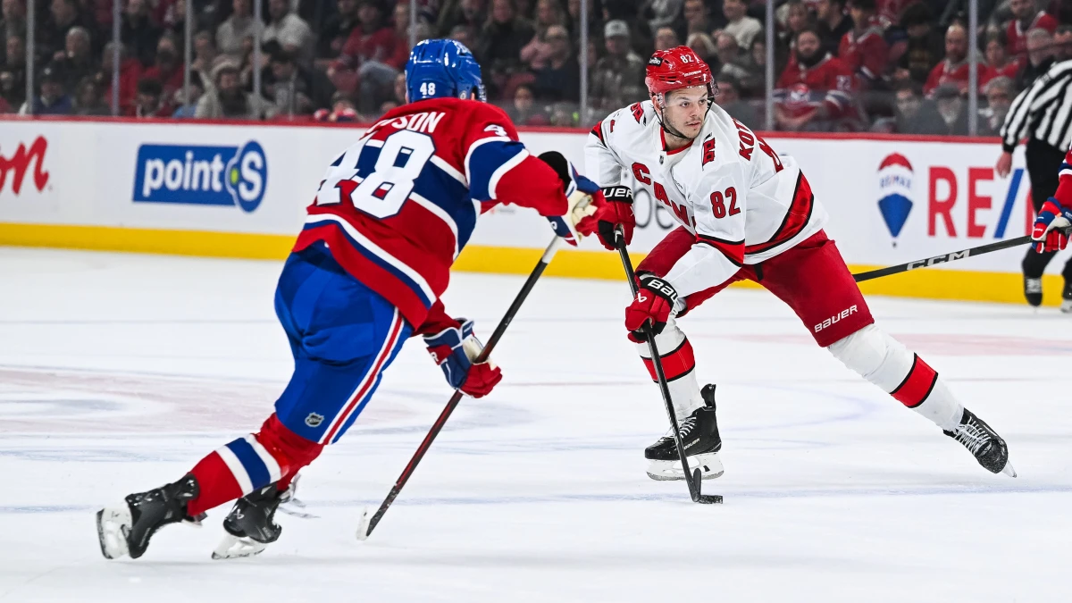 Carolina Hurricanes center Jesperi Kotkaniemi (82) plays the puck against Montreal Canadiens defenseman Lane Hutson (48) in the second period at Bell Centre.