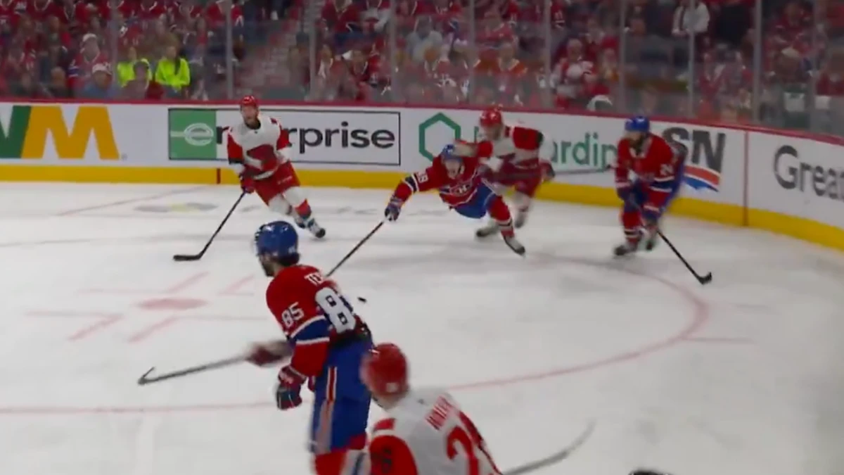 Montreal Canadiens defenseman Lane Hutson (48) is tripped by Carolina Hurricanes left wing Eric Robinson (50) during the second period in game three of the Eastern Conference Final of the 2026 Stanley Cup Playoffs at Bell Centre.