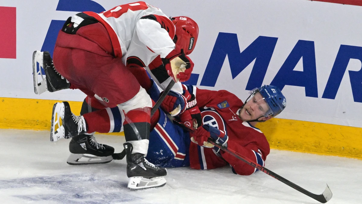 Carolina Hurricanes left wing William Carrier (28) checks Montreal Canadiens defenseman Kaiden Guhle (21) during the third period in game four of the Eastern Conference Final of the 2026 Stanley Cup Playoffs at Bell Centre.