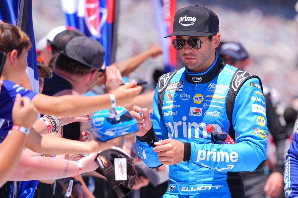 Driver Chase Elliott signs autograph for fans before a NASCAR Cup Series auto race in Fort Worth, Texas, Sunday, May 3, 2026. (AP Photo/LM Otero)