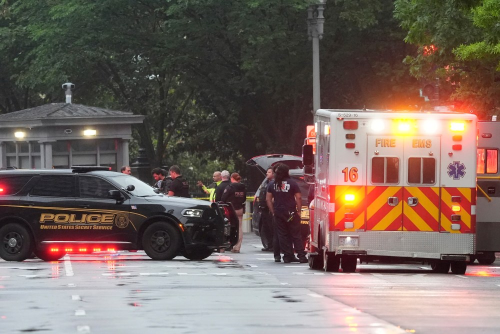 Police and members of the Secret Service stand near an EMS truck after blocking streets around the White House, Saturday, May 23, 2026, in Washington. (AP Photo/Alex Brandon)