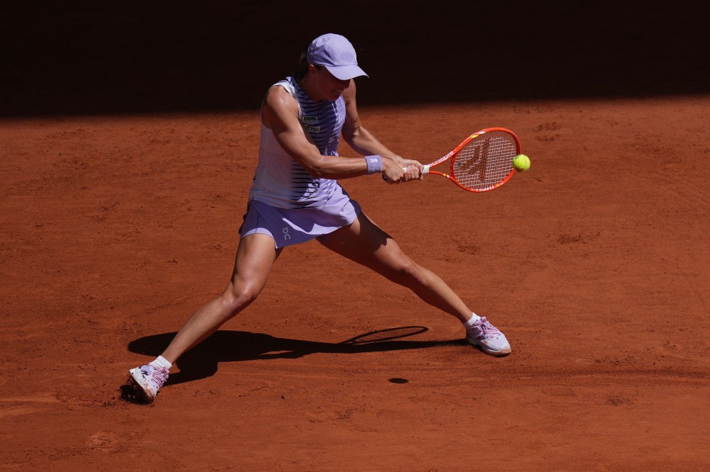 Iga Swiatek of Poland returns to Emerson Jones of Australia during their first round women's singles tennis match at the French Open tennis tournament in Paris, Monday, May 25, 2026. (AP Photo/Thibault Camus)