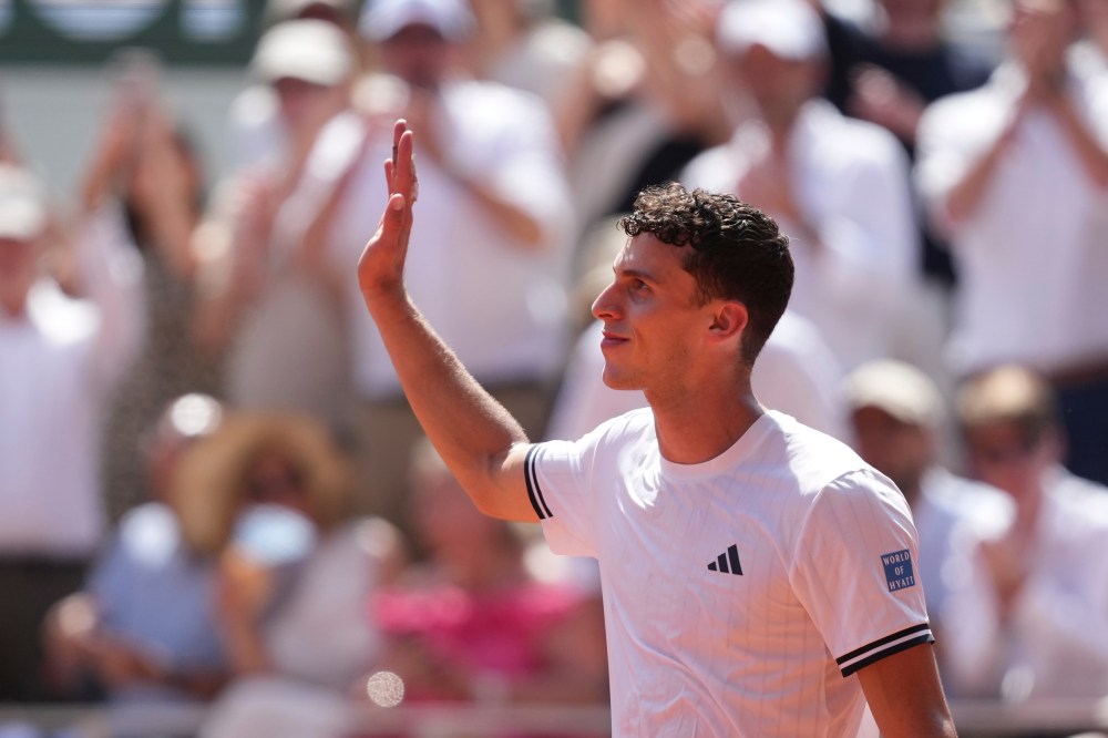 Juan Manuel Cerundolo of Argentina celebrates winning against Jannik Sinner of Italy after their second round men's singles tennis match at the French Open tennis tournament in Paris, Thursday, May 28, 2026. (AP Photo/Thibault Camus)
