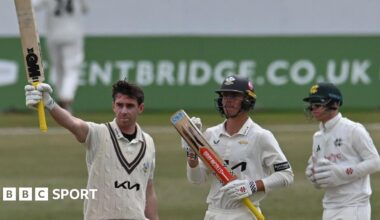 Surrey's Dan Lawrence raises his bat at Trent Bridge after completing a hundred against Nottinghamshire