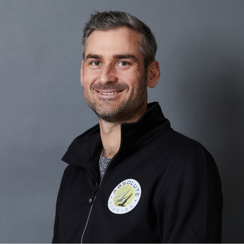 Male Pilates instructor smiles for portrait