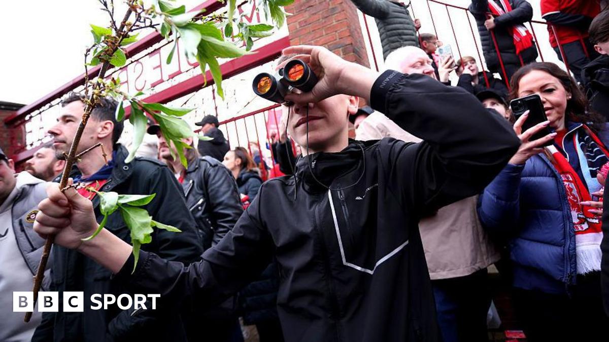 A fan is seen using binoculars outside the stadium prior to the Championship play-off semi-final match between Middlesbrough and Southampton at Riverside Stadium