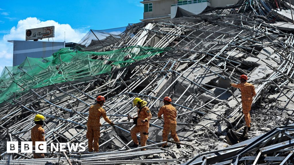 One killed and many feared trapped under collapsed building in Philippines - BBC