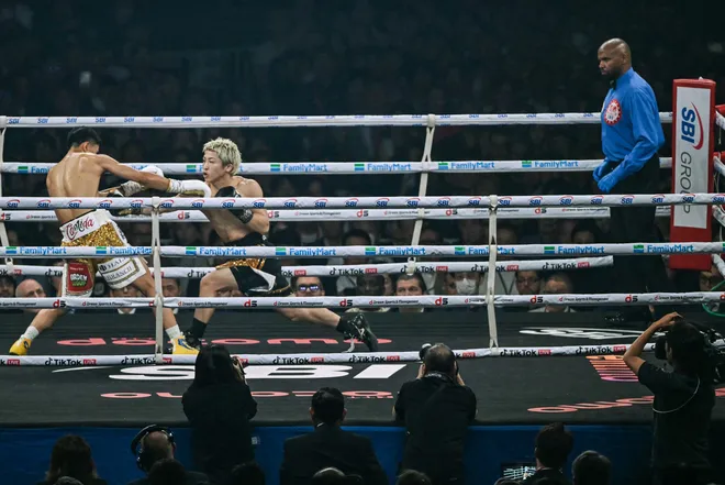 Naoya Inoue (C) fights Junto Nakatani (L) during their super bantamweight championship boxing contest at Tokyo Dome in Tokyo on May 2, 2026. (Photo by Yuichi YAMAZAKI / AFP via Getty Images)