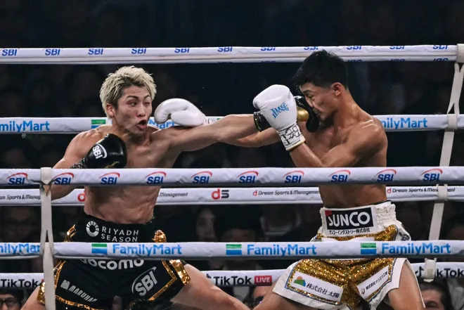 Naoya Inoue (L) fights Junto Nakatani during their super bantamweight championship boxing contest at Tokyo Dome in Tokyo on May 2, 2026. (Photo by Yuichi YAMAZAKI / AFP via Getty Images)
