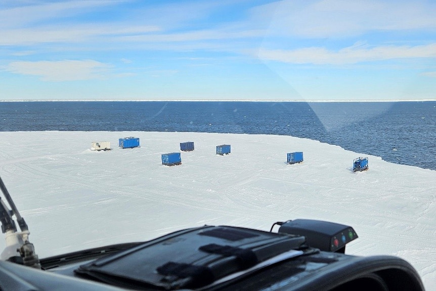 Seven containers seen on an iceberg.