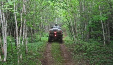 An ATV on a trail through the woods