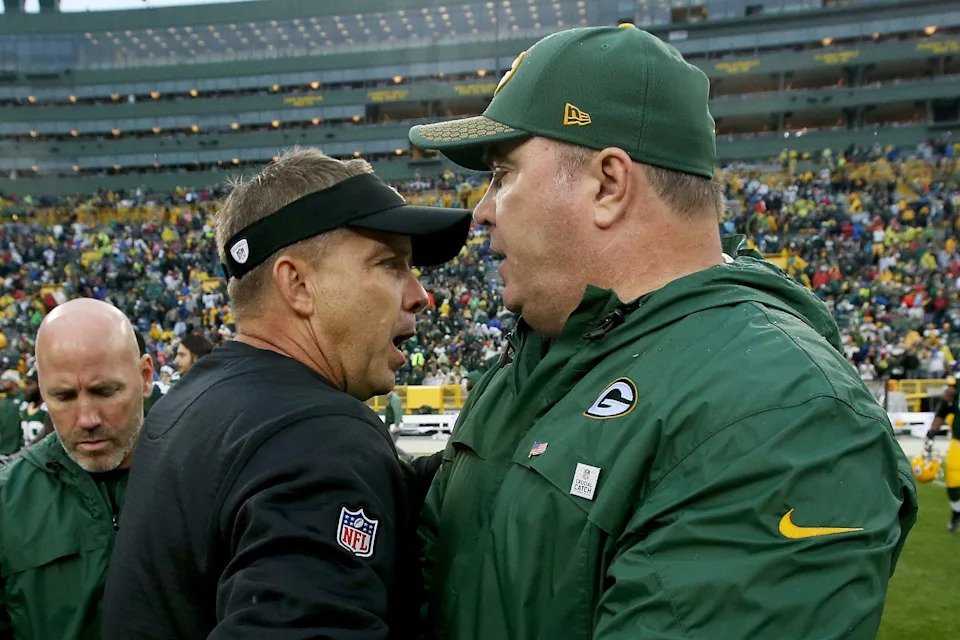 Head coach Sean Payton of the New Orleans Saints and head coach Mike McCarthy of the Green Bay Packers meet after the Saints beat the Packers 26-17 at Lambeau Field on October 22, 2017 in Green Bay, Wisconsin.