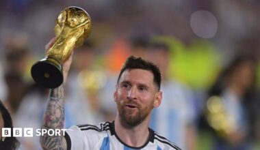 Lionel Messi holding the World Cup trophy