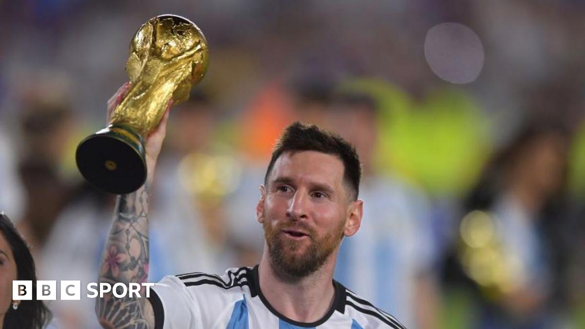 Lionel Messi holding the World Cup trophy