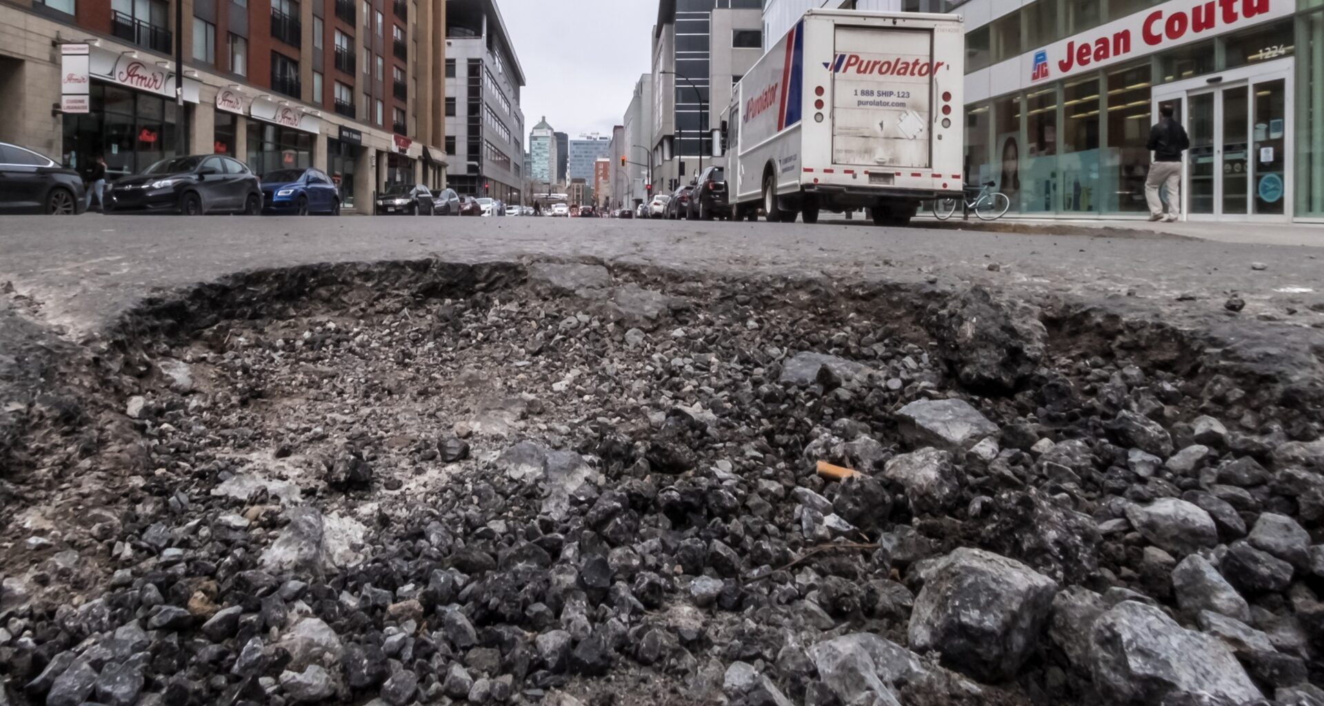 A pothole in the middle of the street.
