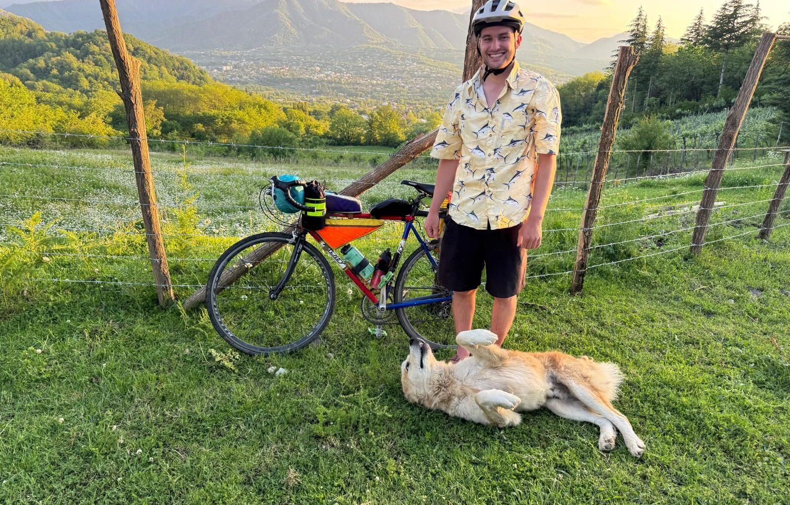Andrew with his bike, and a new canine friend