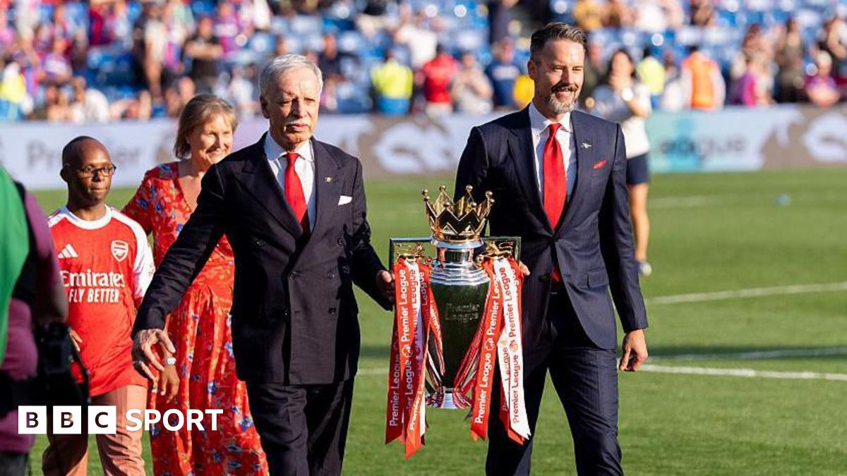 Josh and Stan Kroenke walk trophy out onto pitch